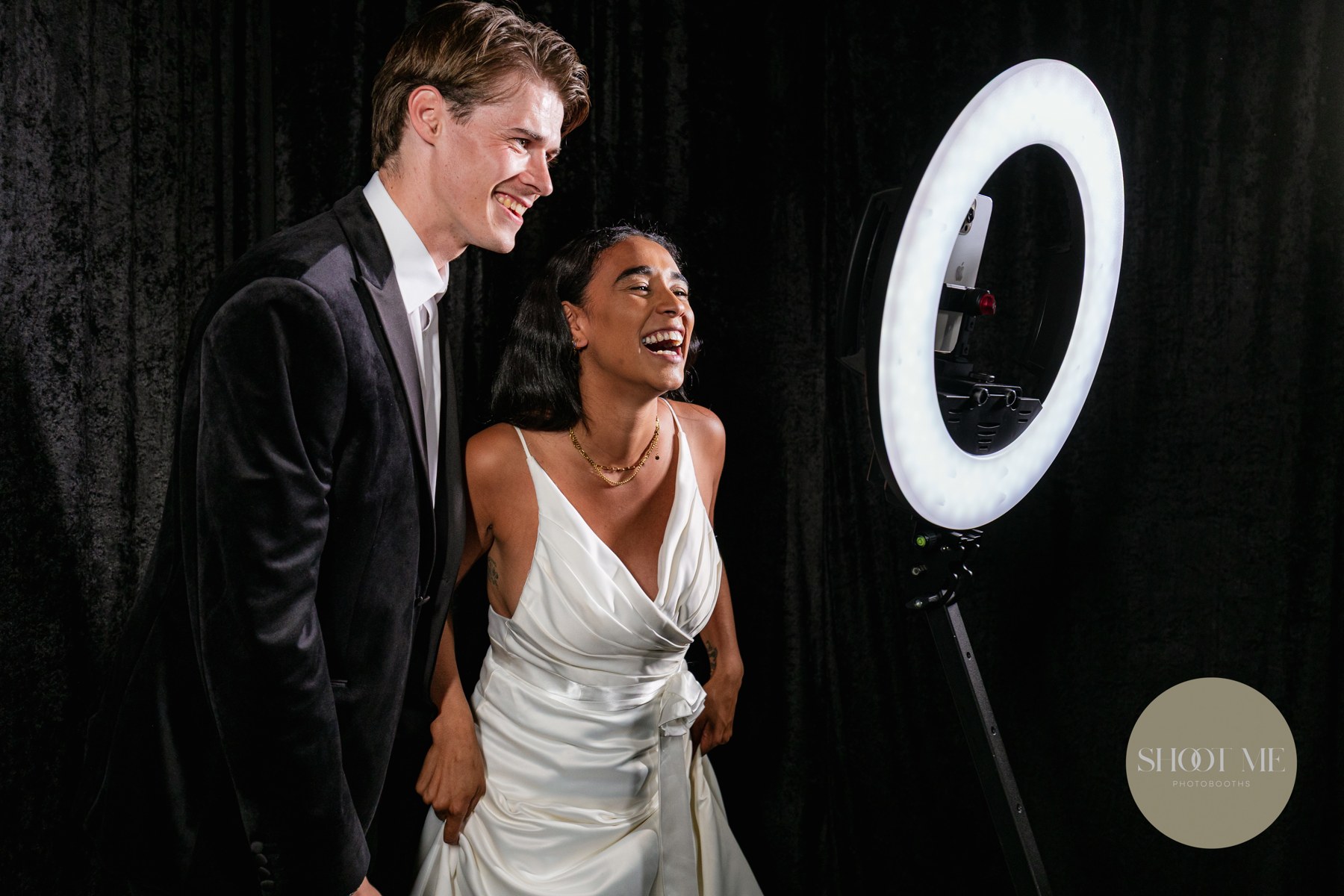 A couple celebrating at their wedding photobooth